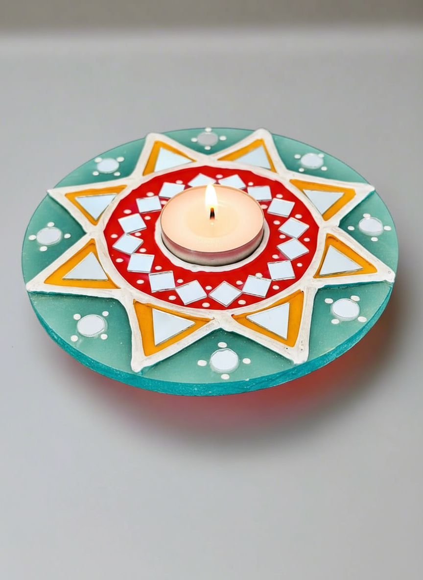 Decorative candle holder with a lit candle on a plain background