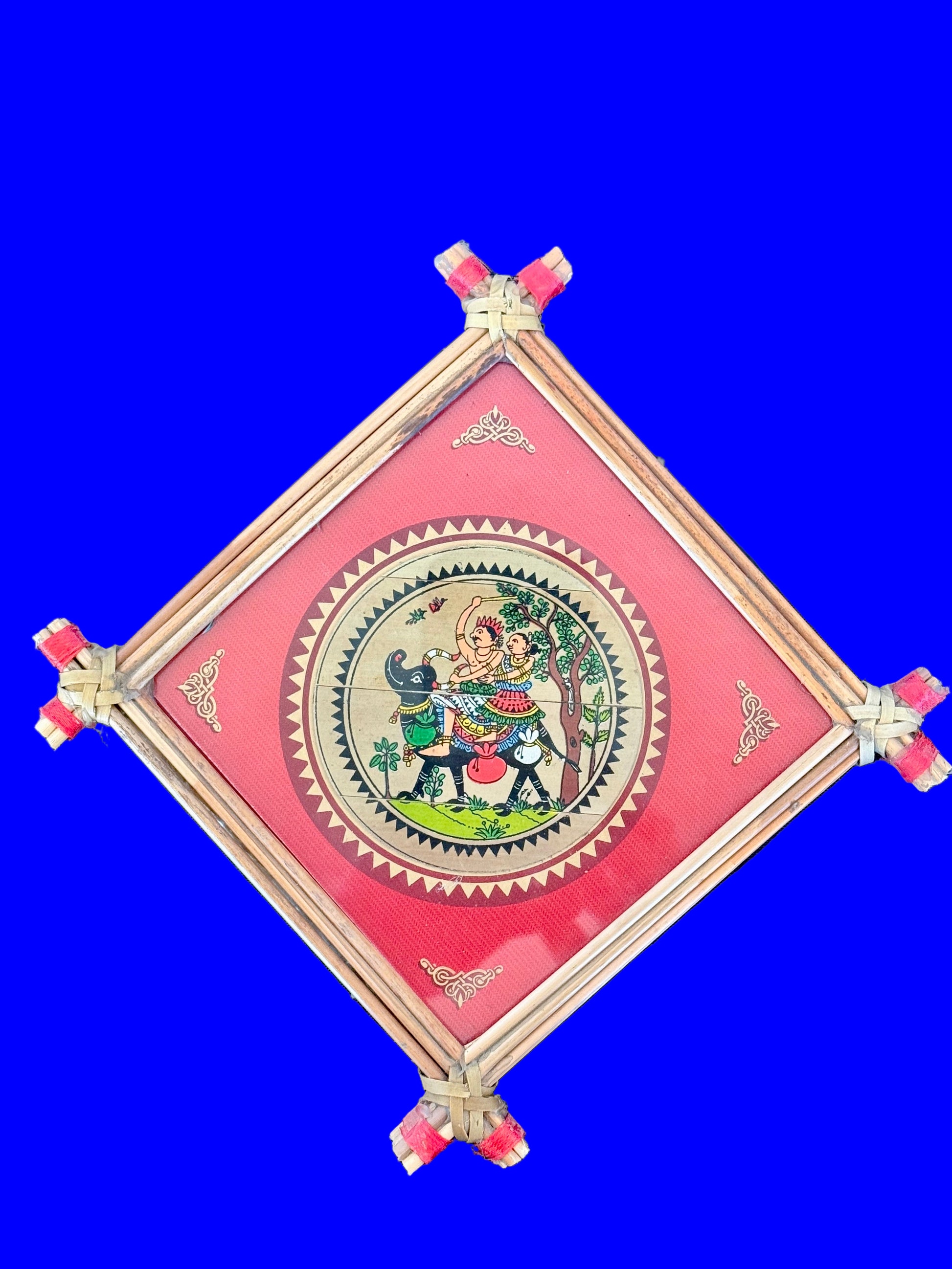 Decorative wall hanging with a pink border and central design on a blue background