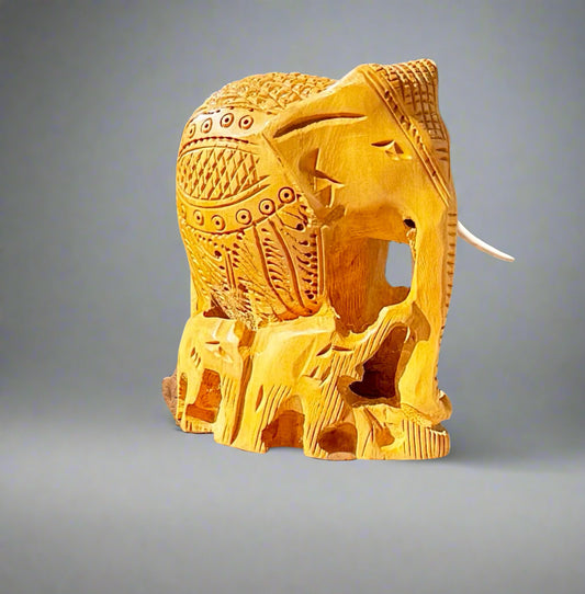 Carved wooden elephant on a wooden surface with a blurred background