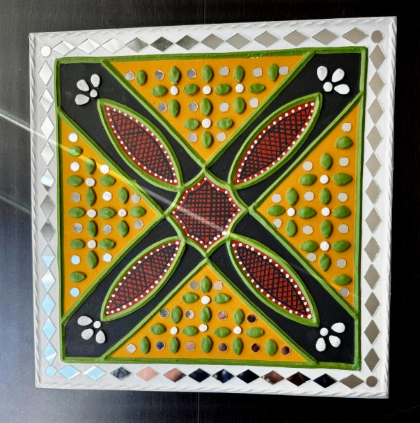 Decorative Lippankaam art tile with geometric pattern on a black background