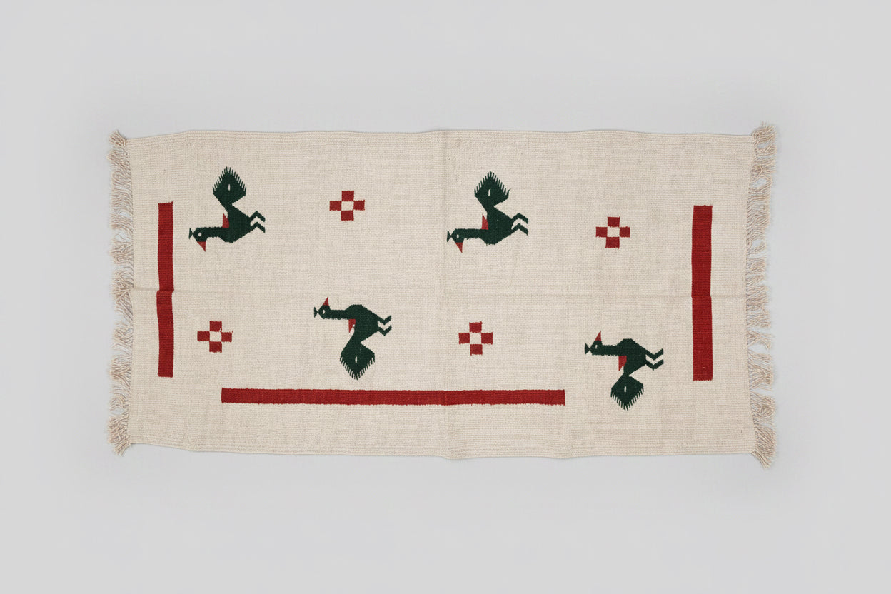 Navalgund rug/Textile with rooster designs on a wooden floor