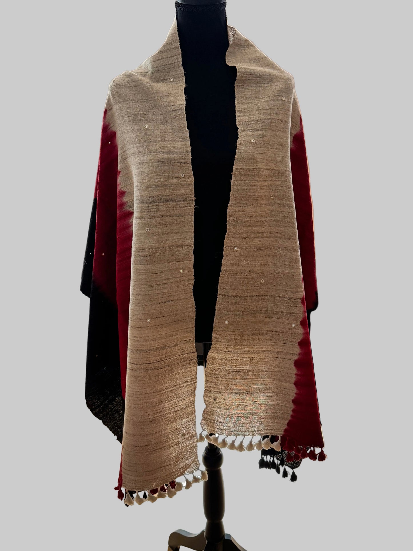 Beige raw silk stole with red and black accents on a mannequin against a neutral background