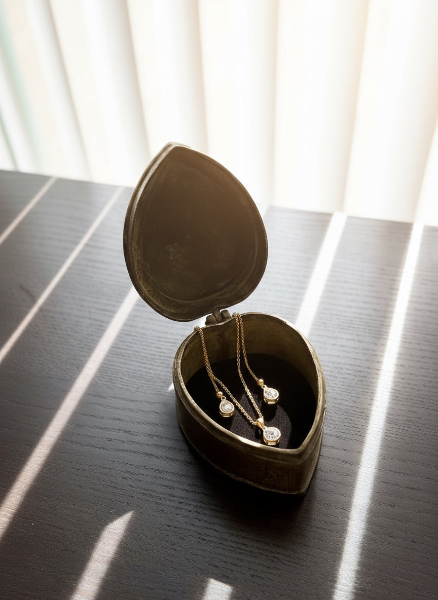 Brass leaf shaped container on a dark surface with light filtering through blinds