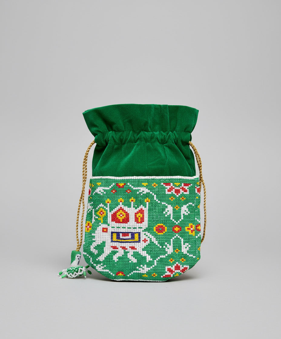 Green embroidered drawstring bag on a gray background