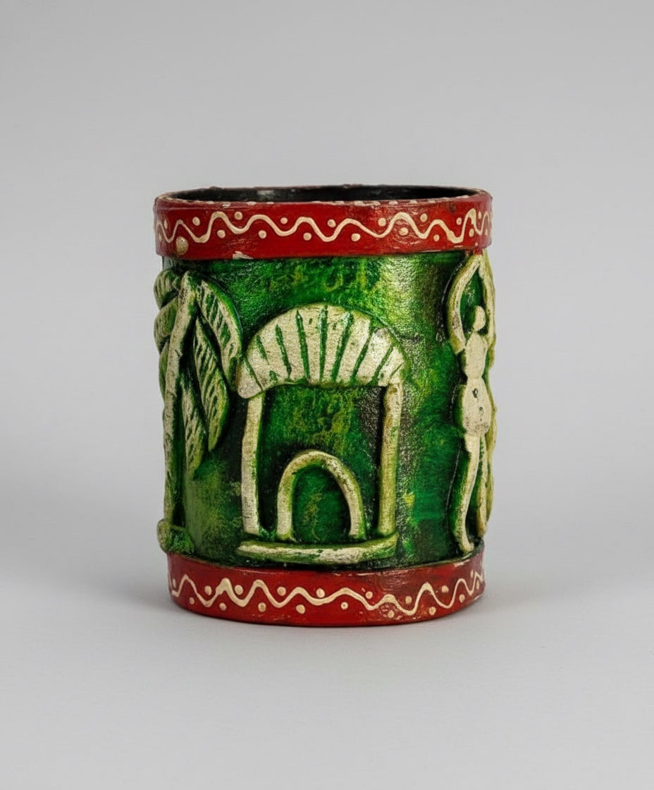 Decorative green ceramic container with red band on a beige surface