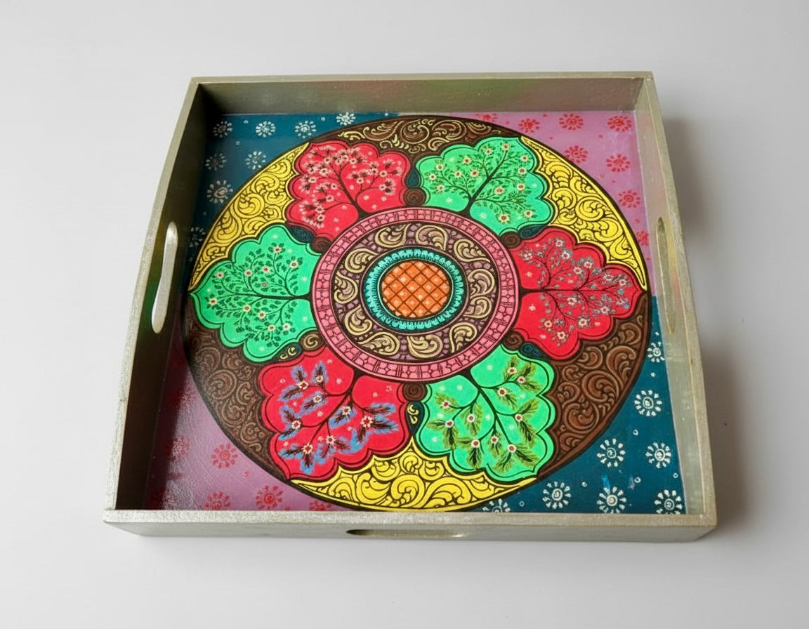 Decorative tray with a colorful circular Pattachitra art design on a white background