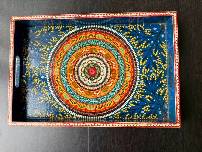 Decorative tray with a colorful circular design on a dark background