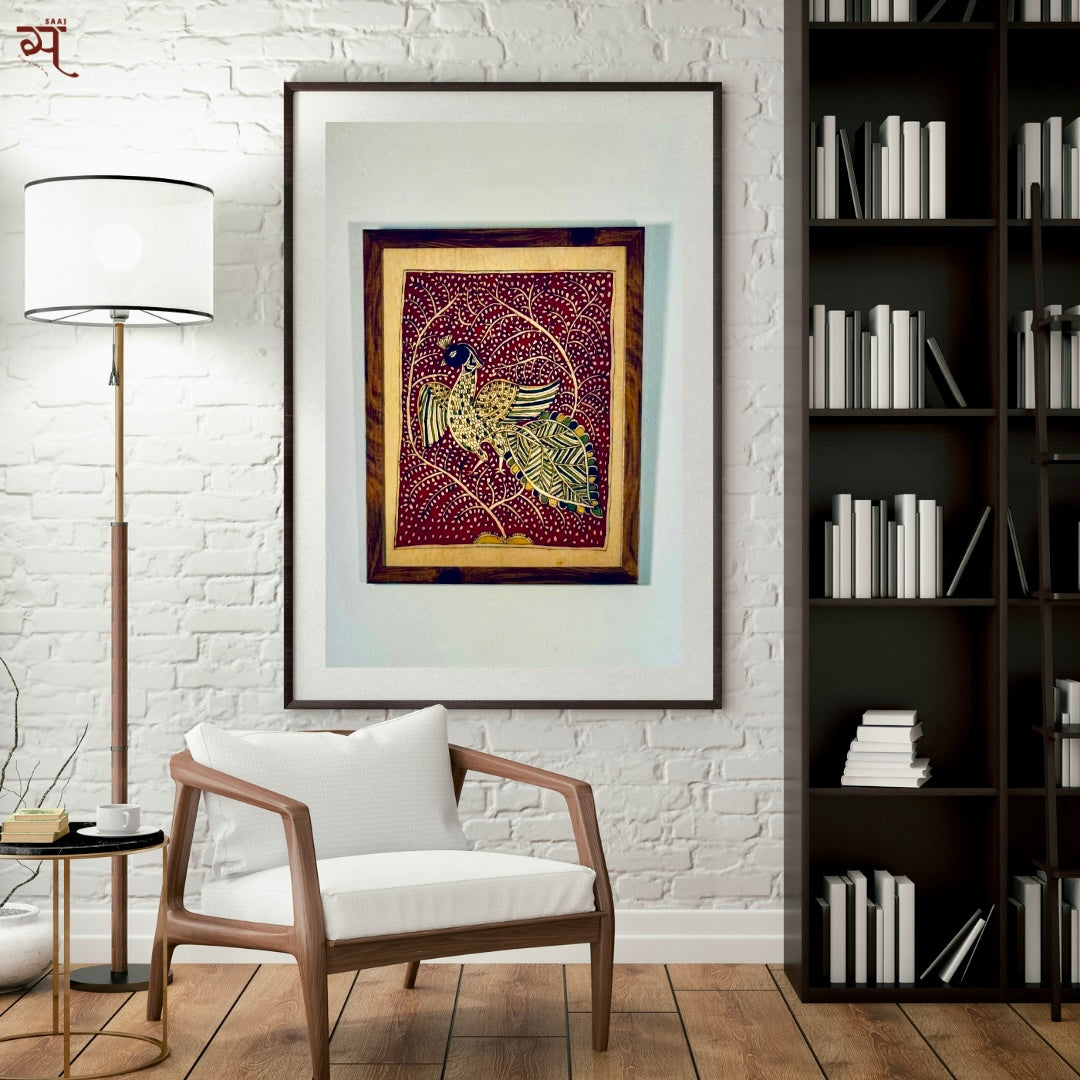 Painting of a peacock in Mata ni Pachhedi style art in a room with bookshelves and a chair and lamp