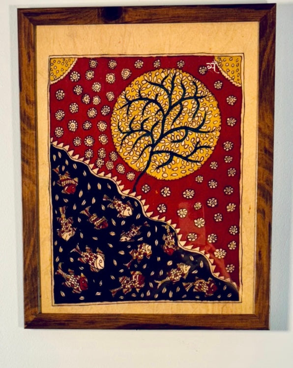 Decorative wall art with a tree of life design in a wooden frame.