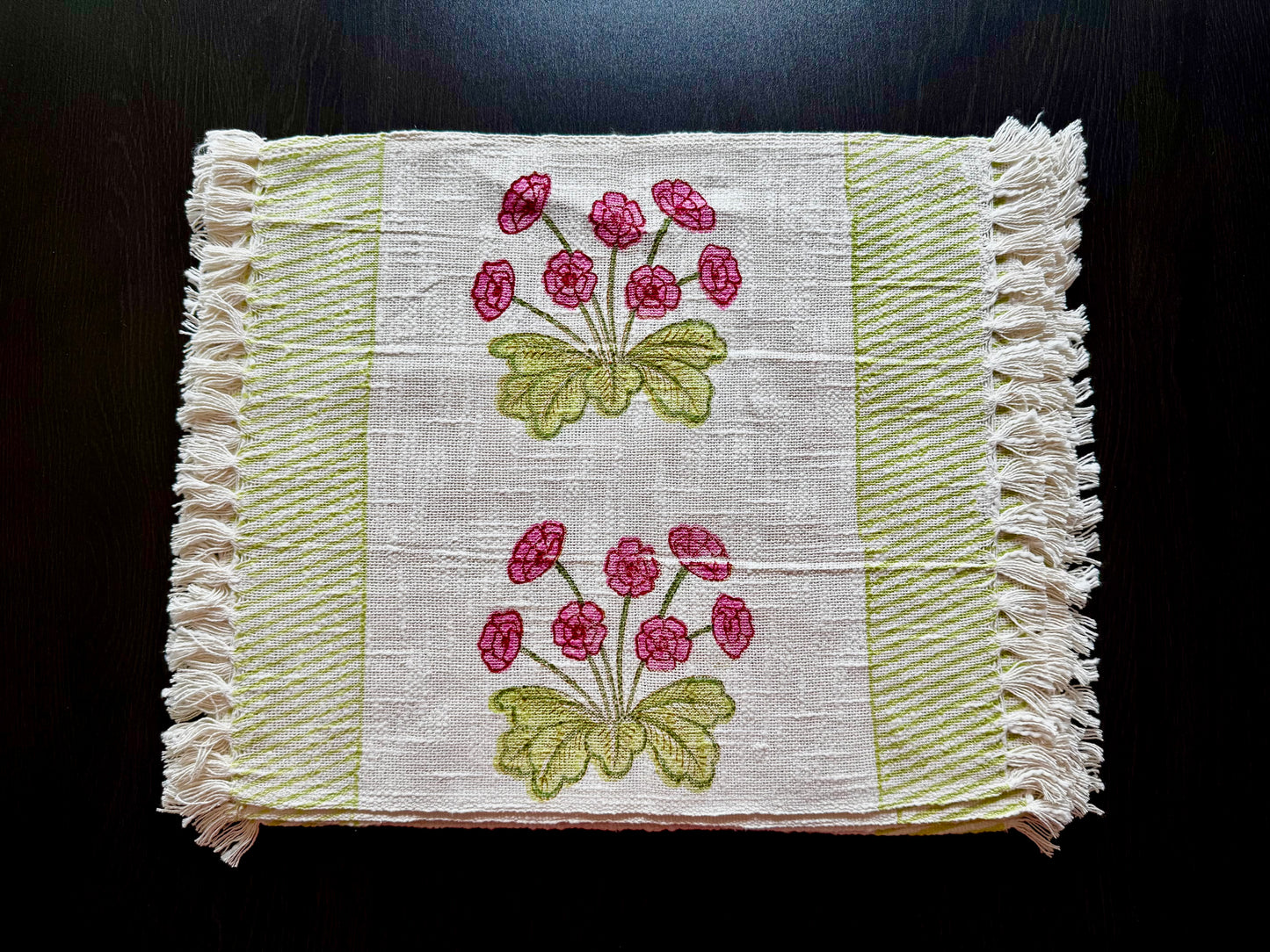 Hand block printed placemats with floral patterns on a dark background