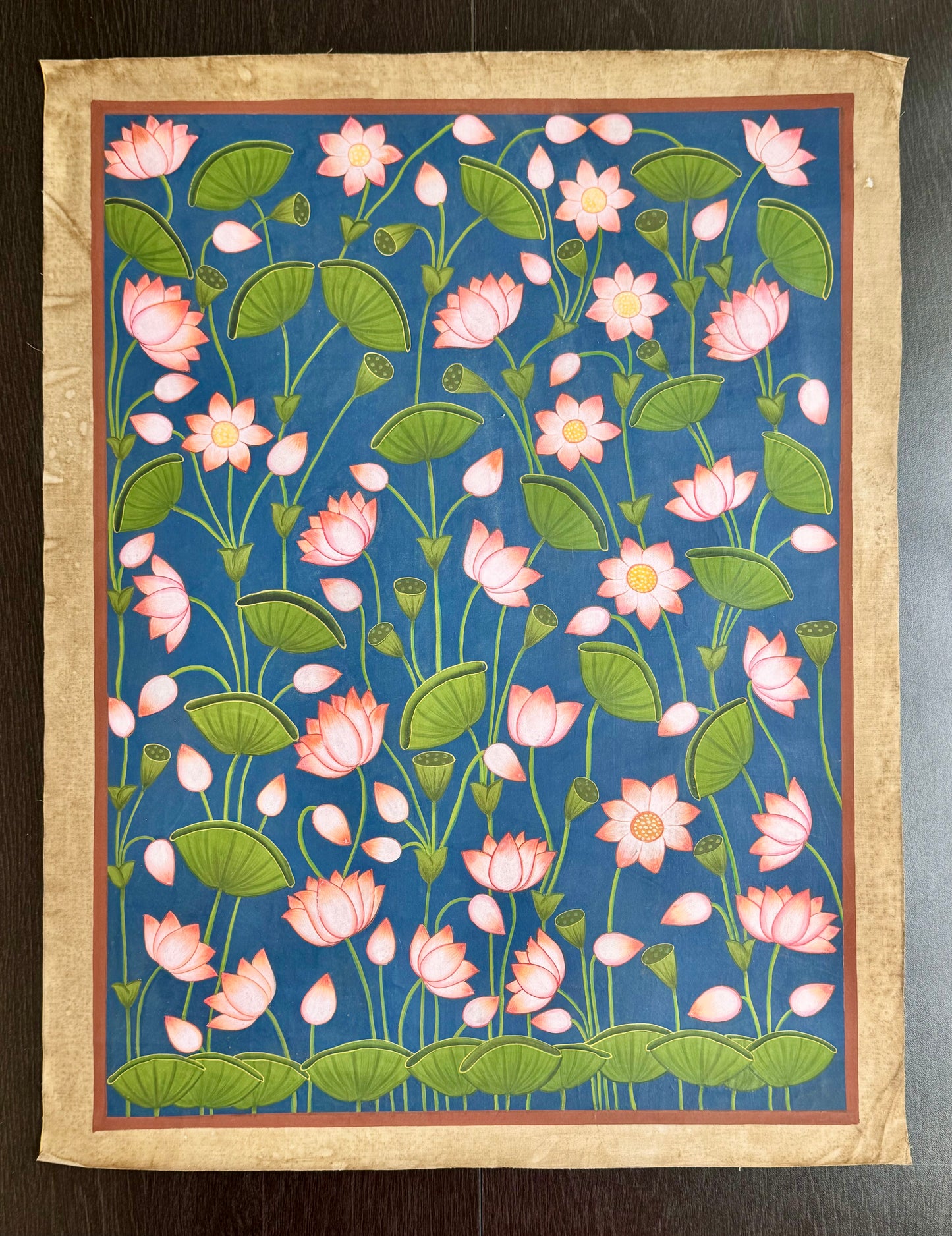 Decorative Pichwai artwork panel with pink lotus flowers on a blue background