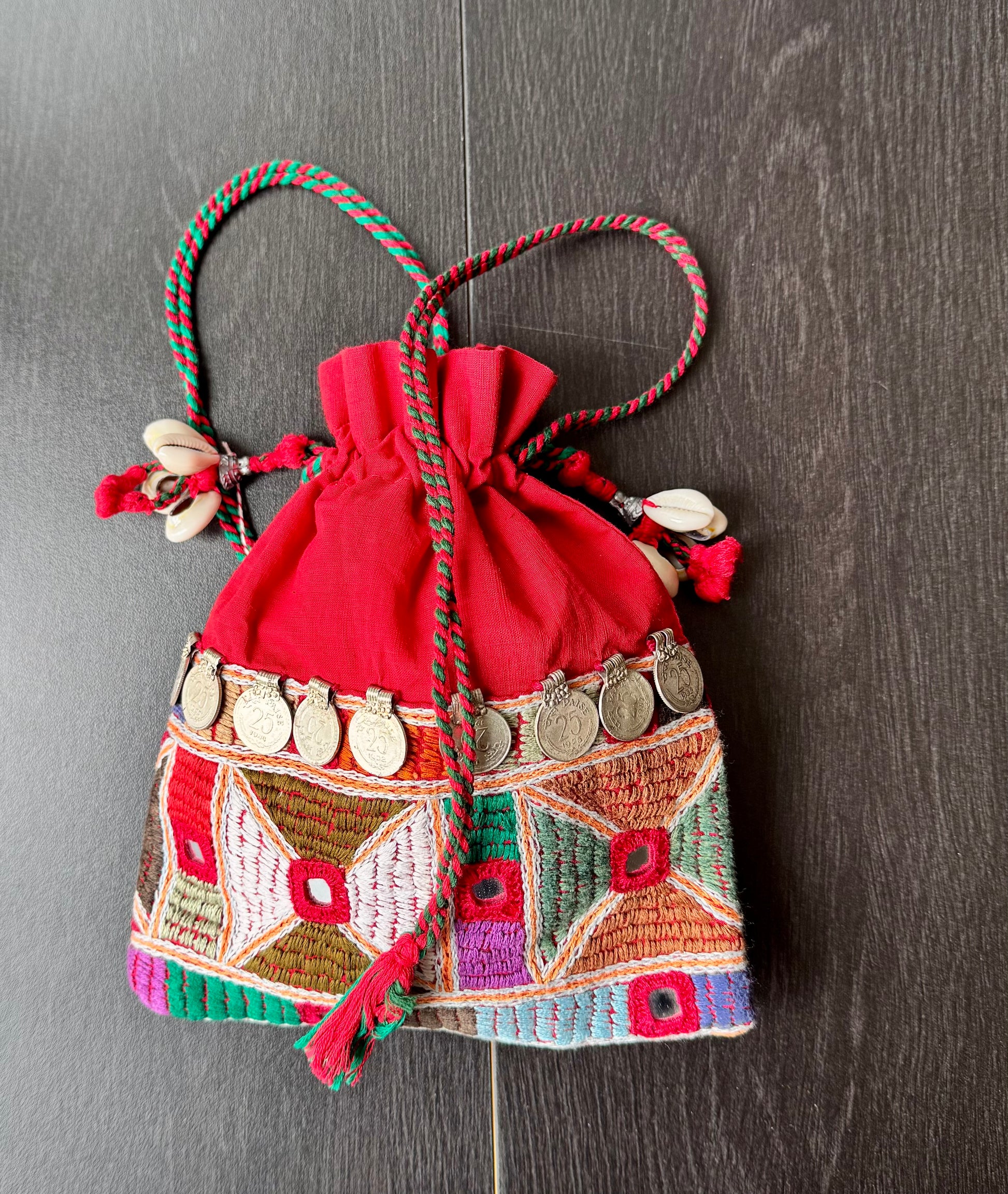 Red potli bag with intricate Lambani embroidery work