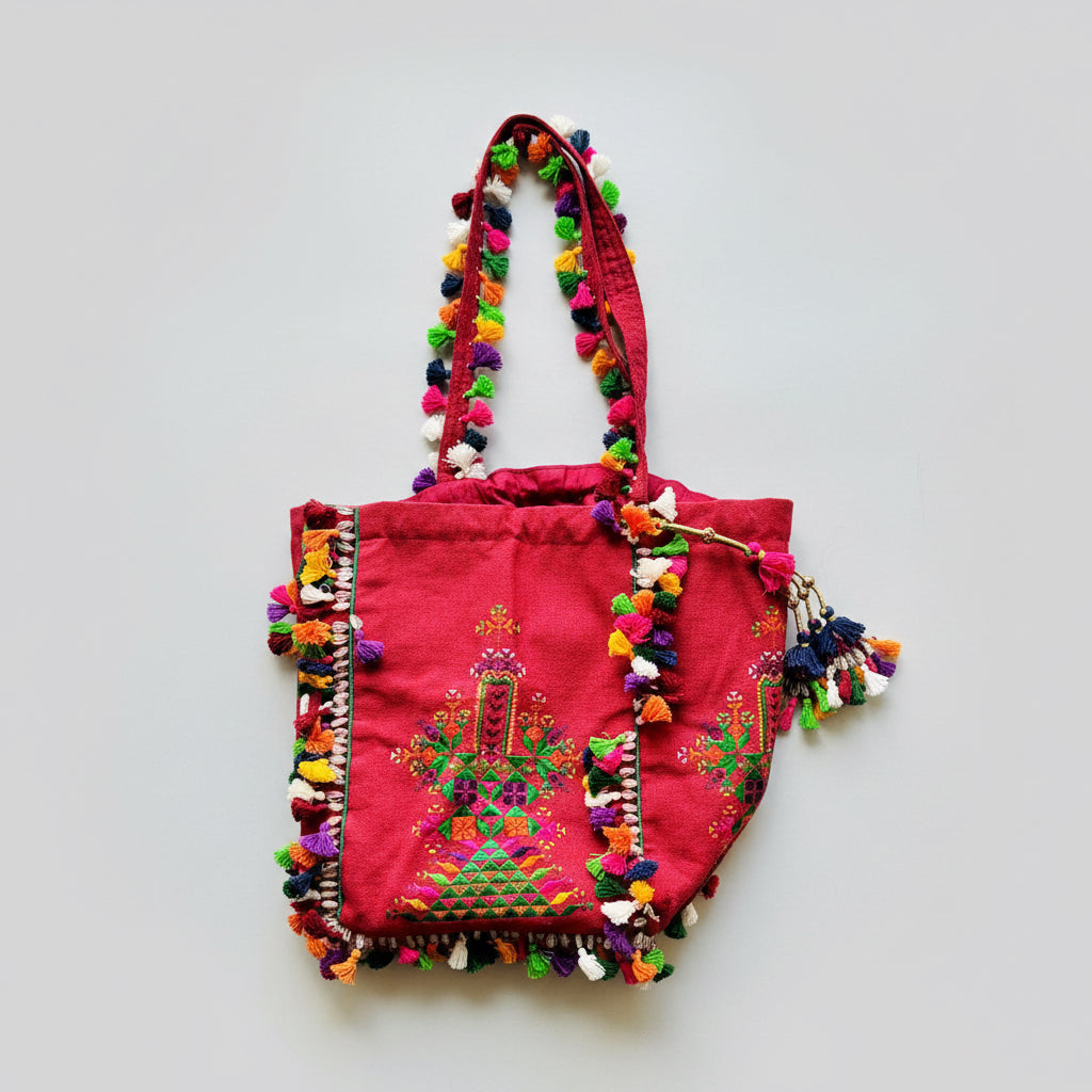 Crimson Kutchi Soof embroidery batwa with embroidered panels and tassel trim