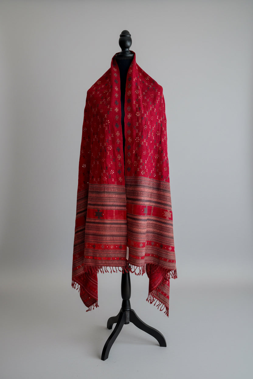 Red patterned hand embroidered Soof style scarf draped over a black mannequin against a plain background
