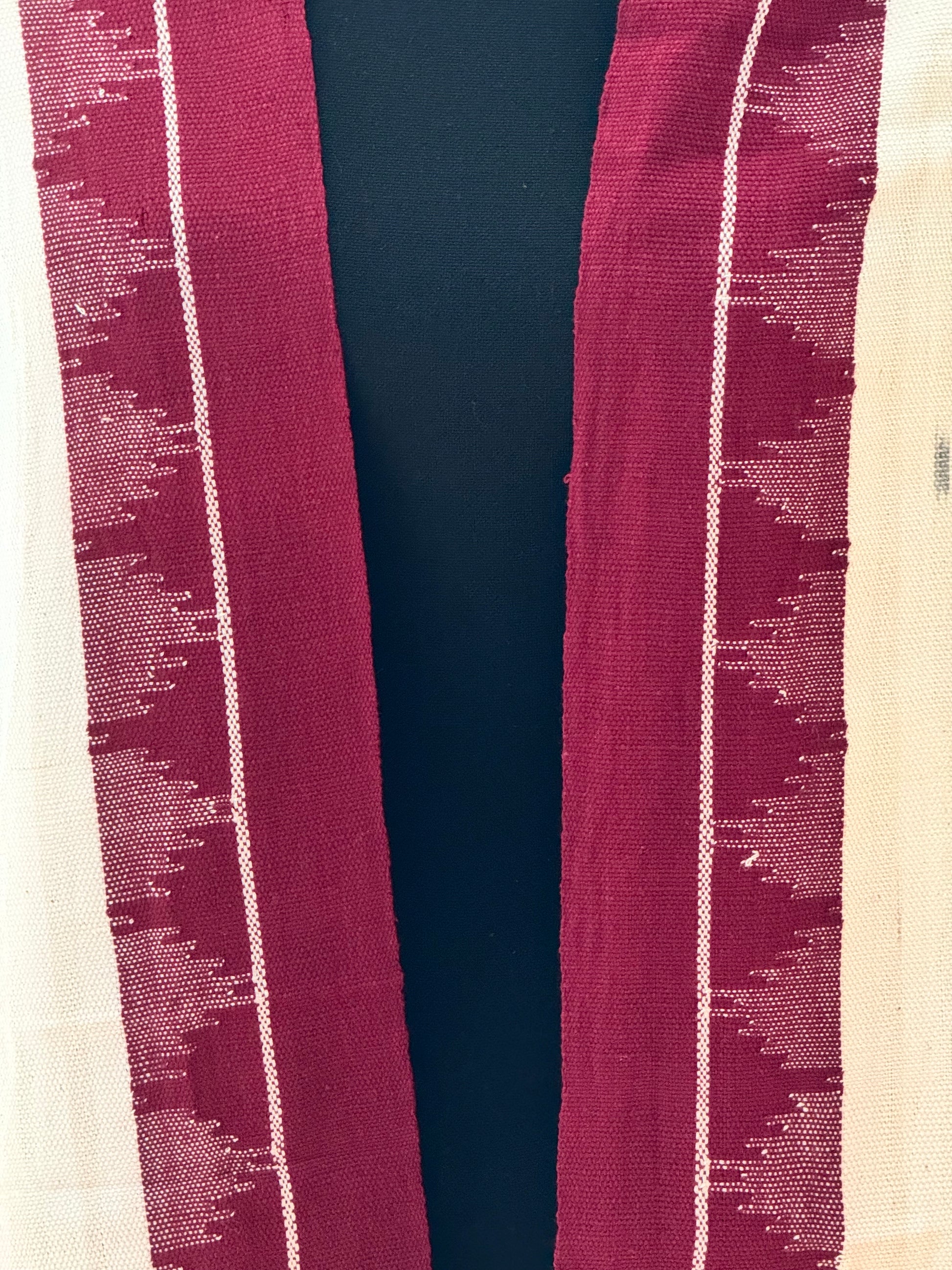 Kotpad weave stole with a pattern of horizontal stripes in beige and red, on a plain background.
