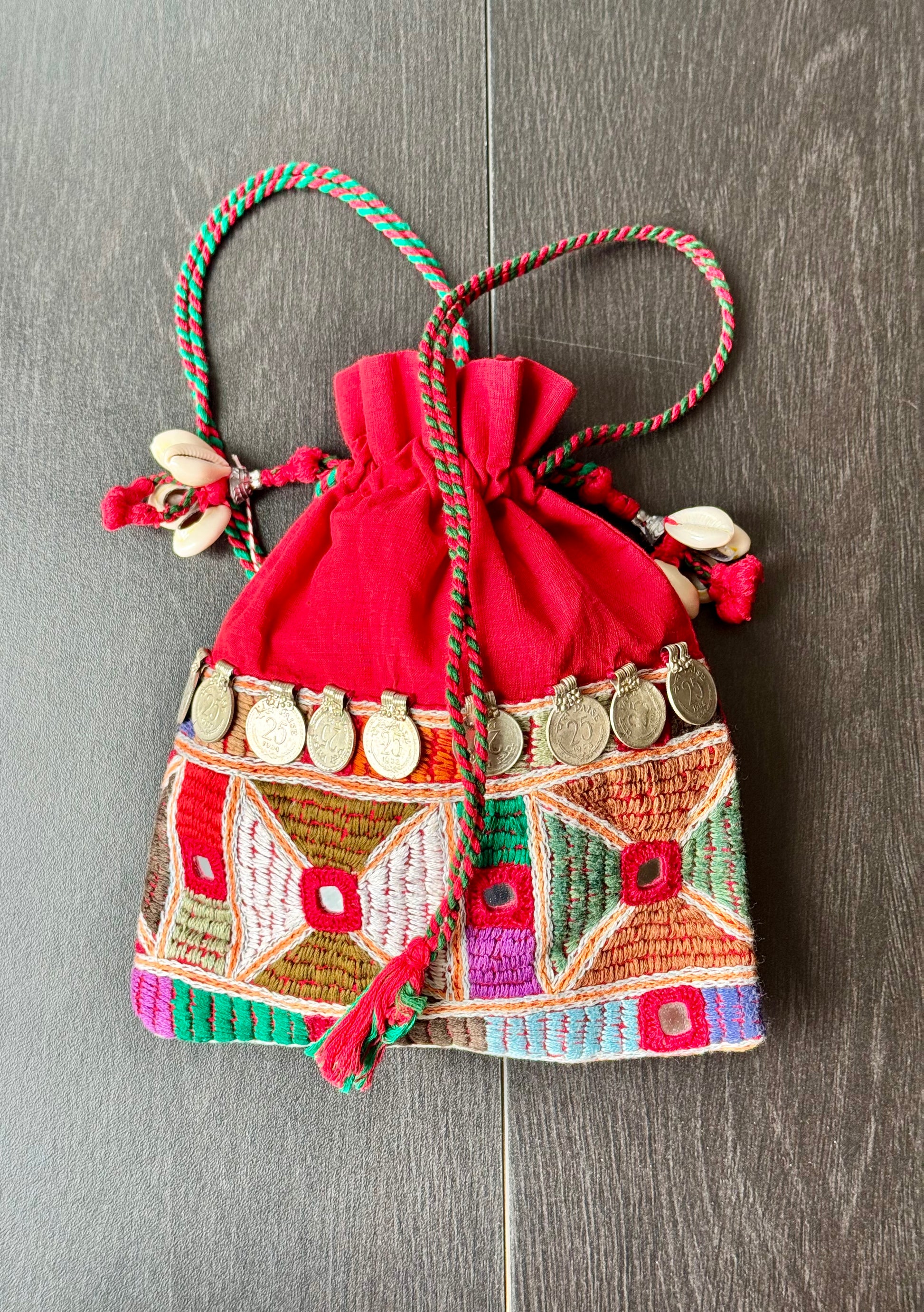 Red potli bag with intricate Lambani embroidery work
