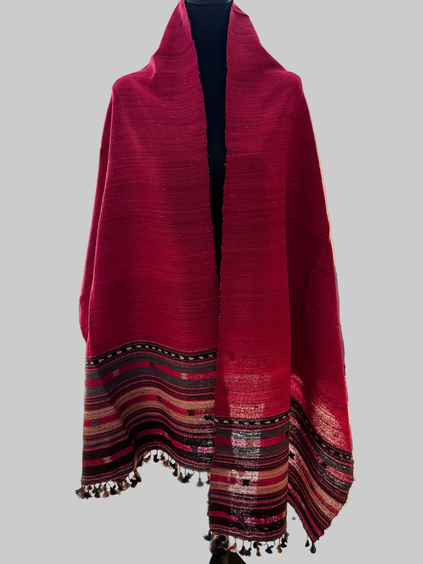 Red raw silk stole with black and white patterns on a stand