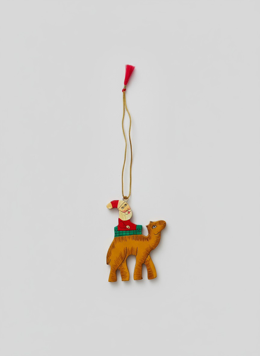 Decorative Christmas ornament of a camel with a Santa hat on a white background