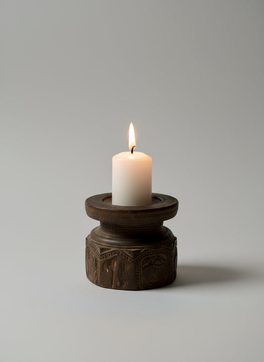 Dark wooden candle holder on a textured surface