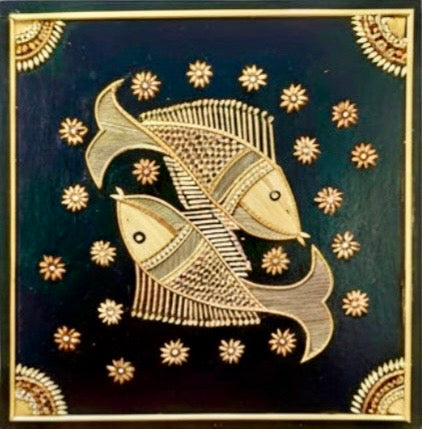 Decorative tile with gold fish design on a dark blue background