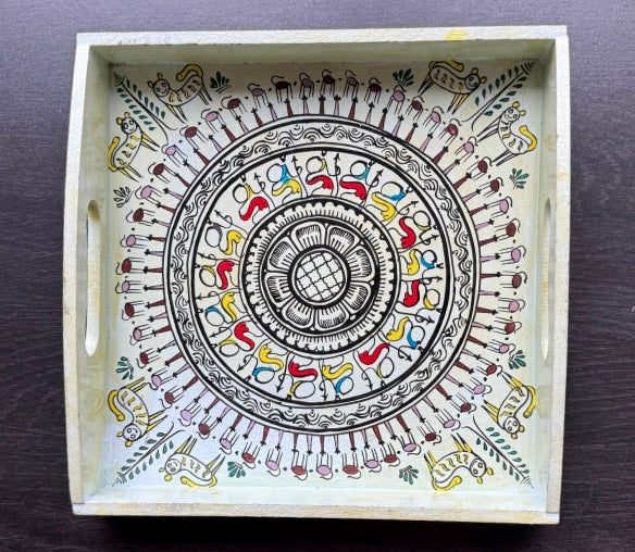 Decorative wooden tray with a circular mandala design on a dark surface