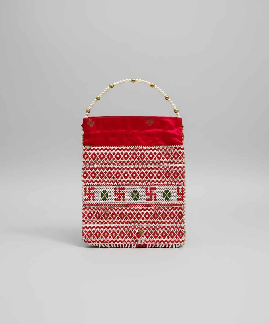 Red fabric and pearls Batwa pouch with white pattern on a gray background