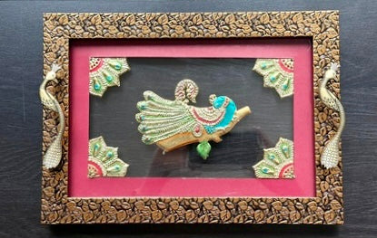 Decorative frame with a pink background and intricate designs on a dark surface