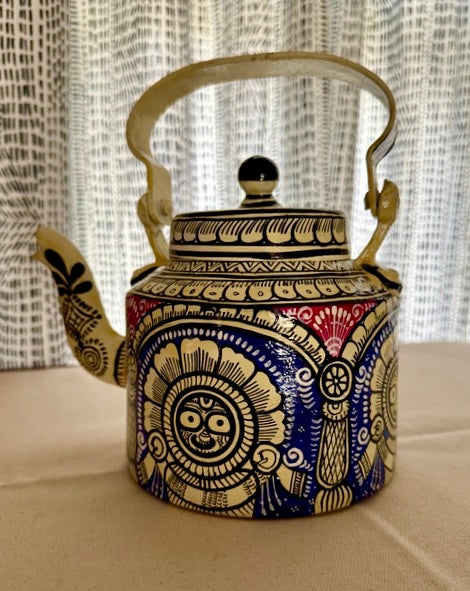 Decorative teapot with intricate patterns on a neutral background