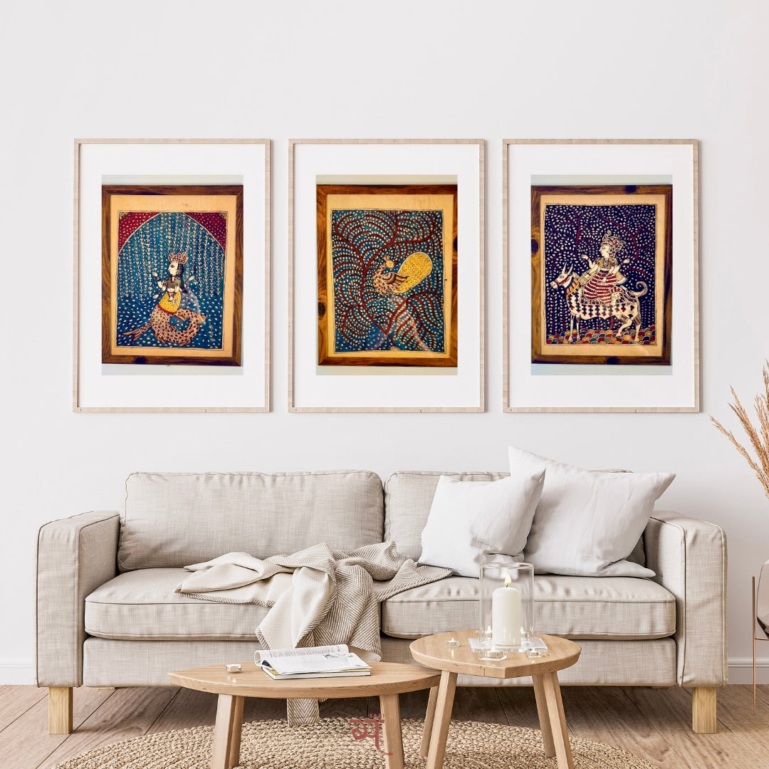 Living room with a beige sofa, wooden coffee table, and three framed artworks on the wall.
