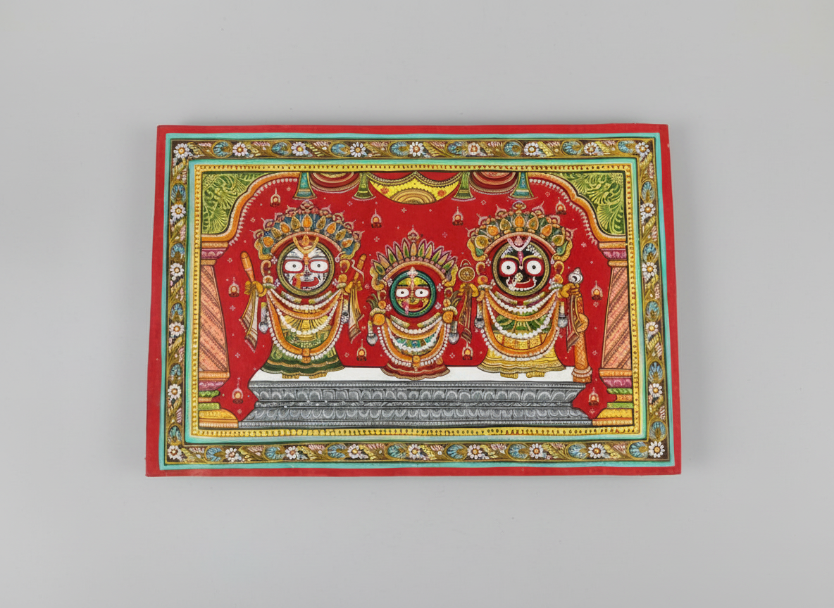 Decorative artwork with three deities in ornate attire on a red background
