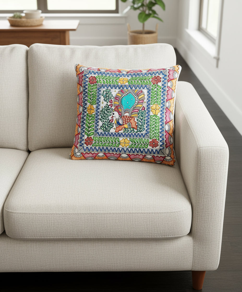 Colorful hand-drawn Madhubani design on a white cushion cover