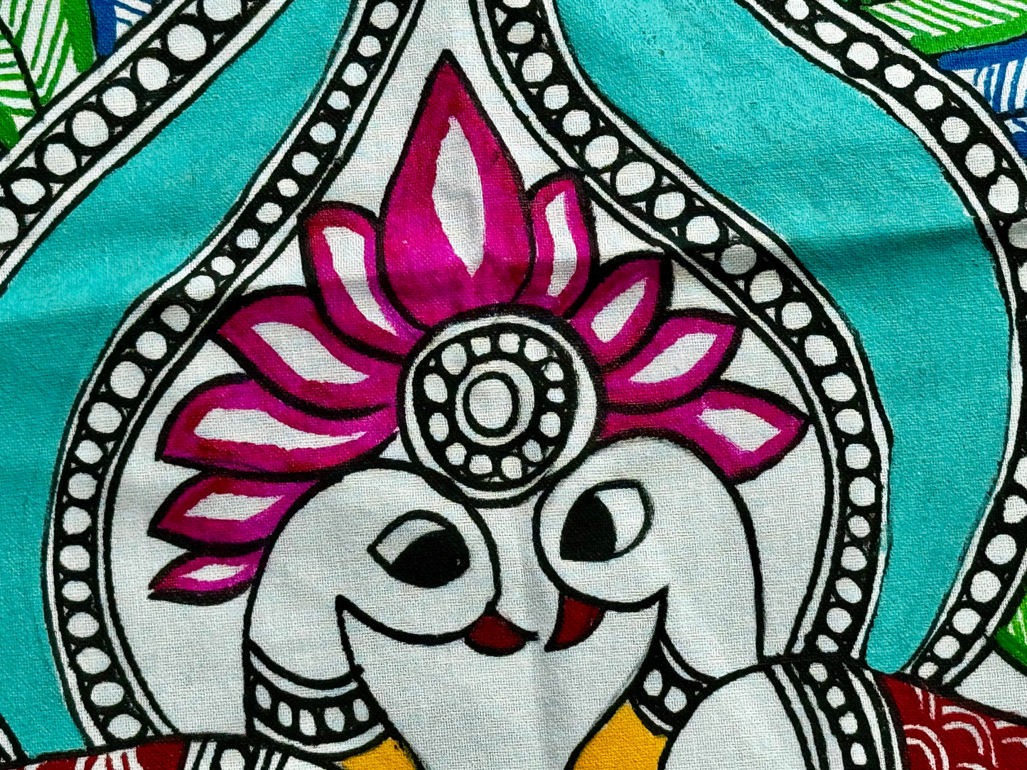 Decorative fabric with a stylized peacocks and floral design on a turquoise background