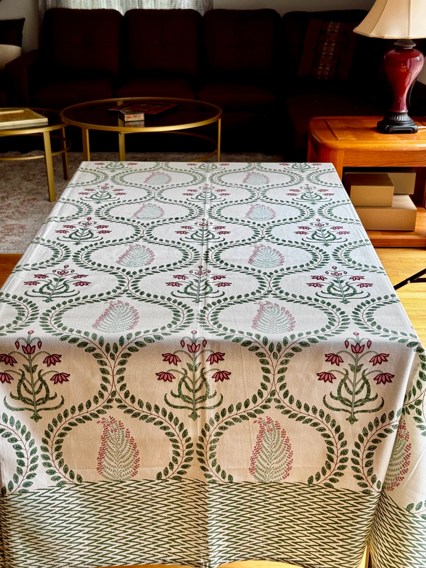 Decorative hand block print tablecloth with a geometric pattern on a table in a living room setting.