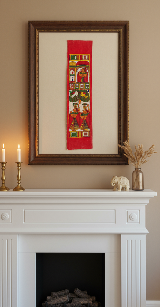 Framed artwork above a fireplace with candles and decorative items.