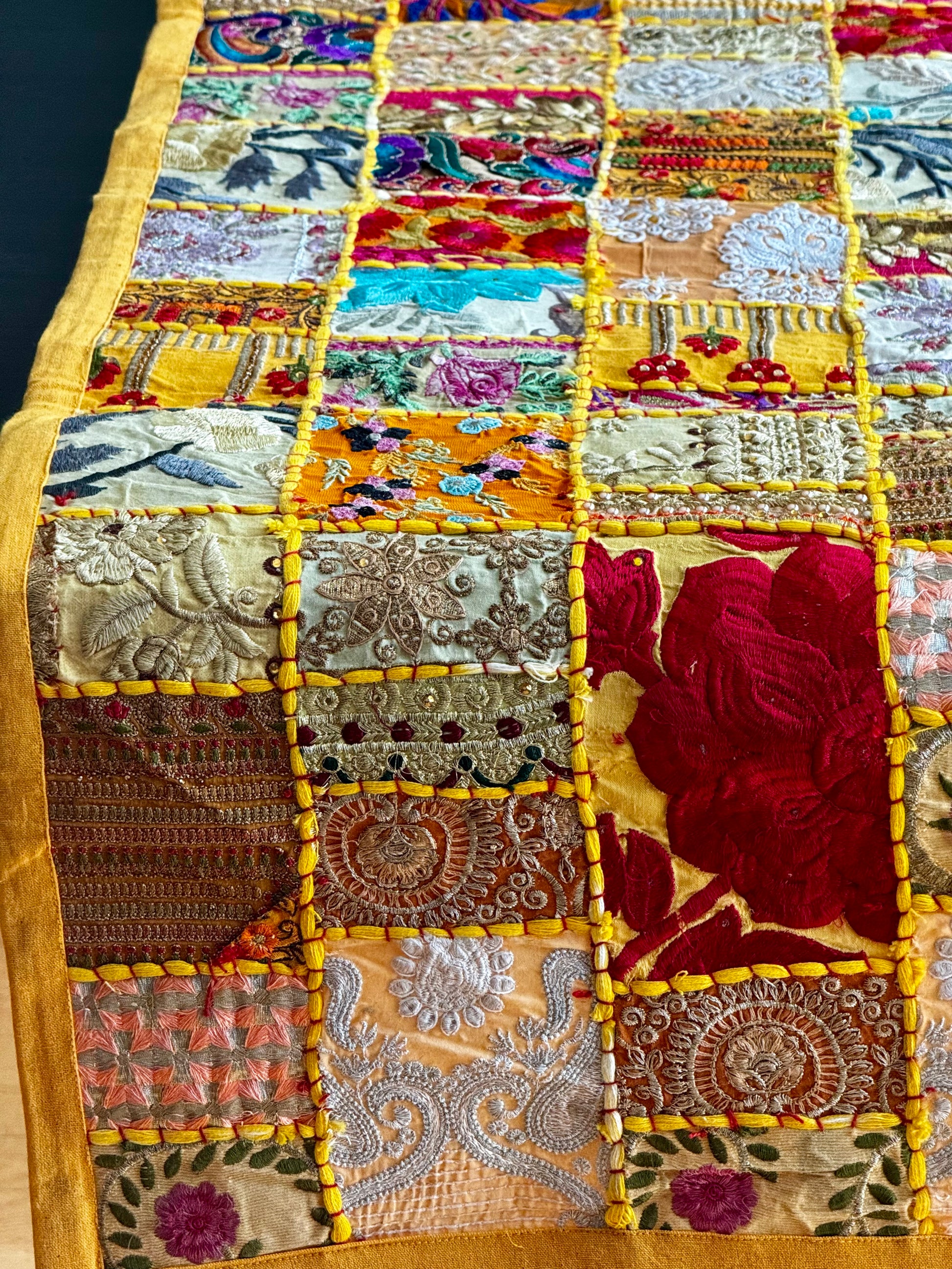 Colorful Khambhadia patchwork fabric with intricate patterns and embroidery.